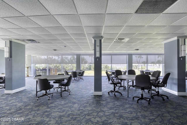 interior space with expansive windows, plenty of natural light, and dark carpet