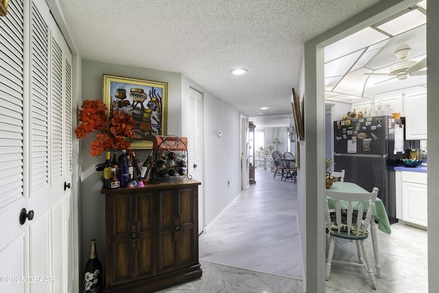 hallway featuring a textured ceiling