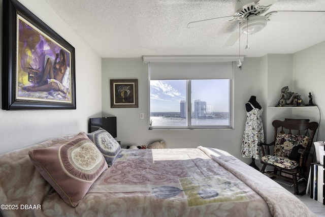 bedroom with a textured ceiling and ceiling fan