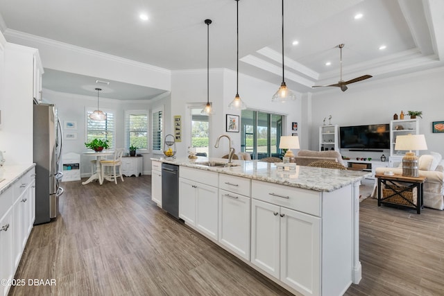 kitchen with sink, white cabinetry, hanging light fixtures, a center island with sink, and appliances with stainless steel finishes