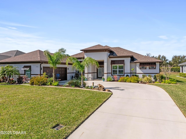 view of front facade with a garage and a front lawn