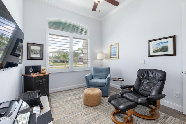 living area featuring crown molding, ceiling fan, and hardwood / wood-style floors