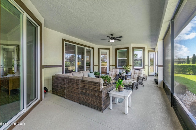 sunroom / solarium featuring ceiling fan