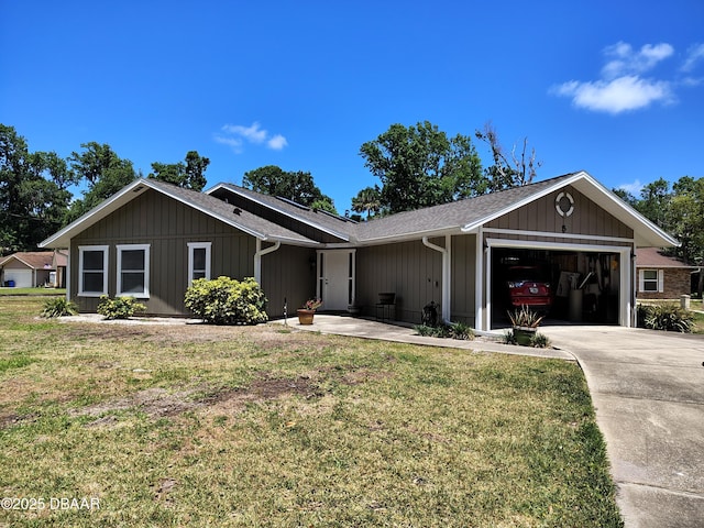 ranch-style house featuring board and batten siding, a front yard, a garage, and driveway