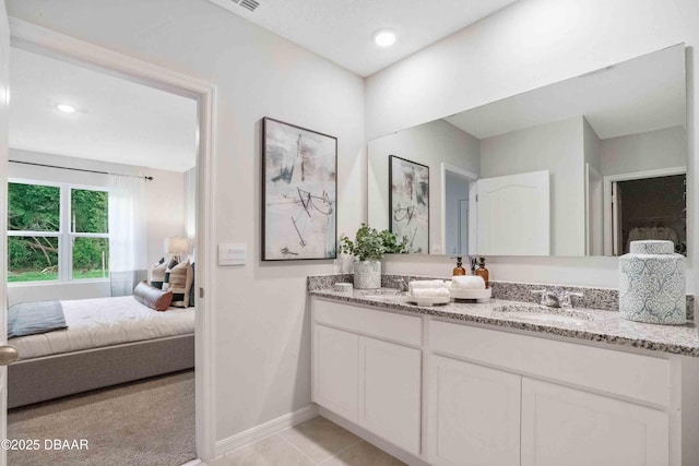 bathroom featuring tile patterned flooring and vanity