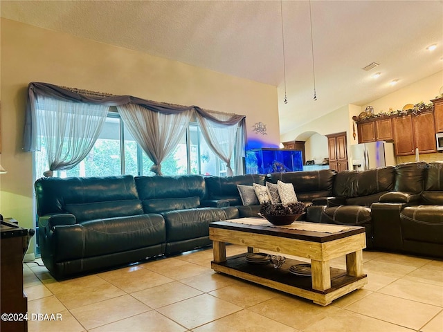 tiled living room with lofted ceiling and a textured ceiling