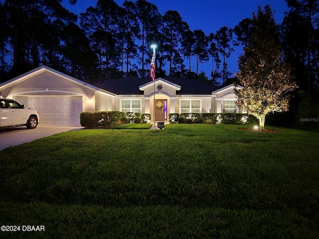 single story home with a garage and a lawn