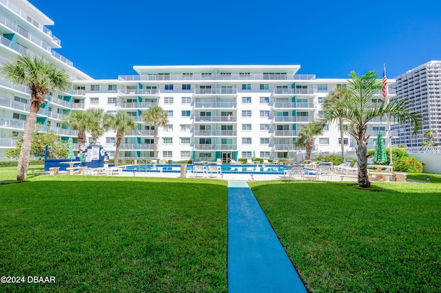 view of building exterior with a community pool