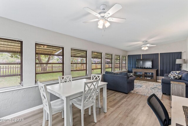 1317 Dexter Dr W, Port Orange, FL 32129 - dining area featuring ceiling fan, light wood-style flooring, a textured wall, and baseboards