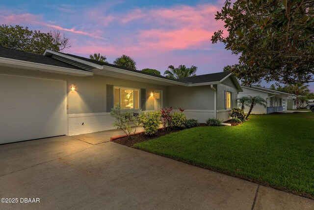 1317 Dexter Dr W, Port Orange, FL 32129 - view of front facade with brick siding, concrete driveway, a garage, and a yard