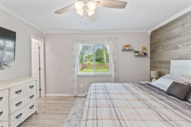 1317 Dexter Dr W, Port Orange, FL 32129 - bedroom with crown molding, light wood finished floors, baseboards, wooden walls, and a ceiling fan