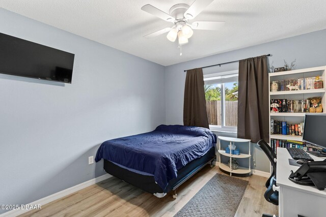 1317 Dexter Dr W, Port Orange, FL 32129 - bedroom with light wood finished floors, a desk, baseboards, and a ceiling fan