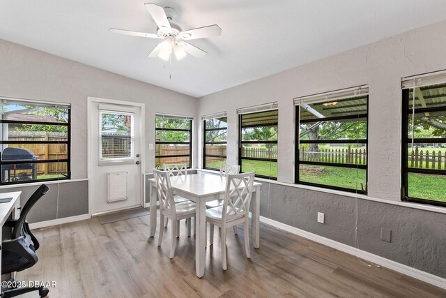 1317 Dexter Dr W, Port Orange, FL 32129 - dining space featuring lofted ceiling, baseboards, a textured wall, light wood-style flooring, and ceiling fan