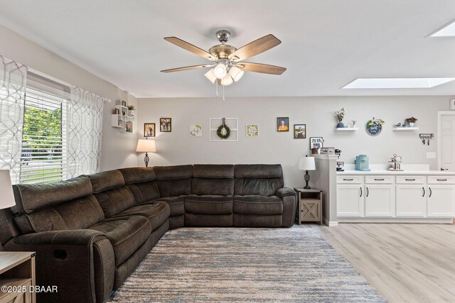 1317 Dexter Dr W, Port Orange, FL 32129 - living area with a skylight, a ceiling fan, and light wood finished floors