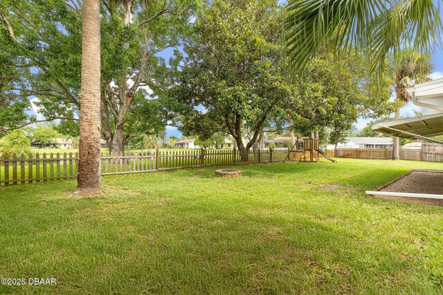 1317 Dexter Dr W, Port Orange, FL 32129 - view of yard with a playground and a fire pit