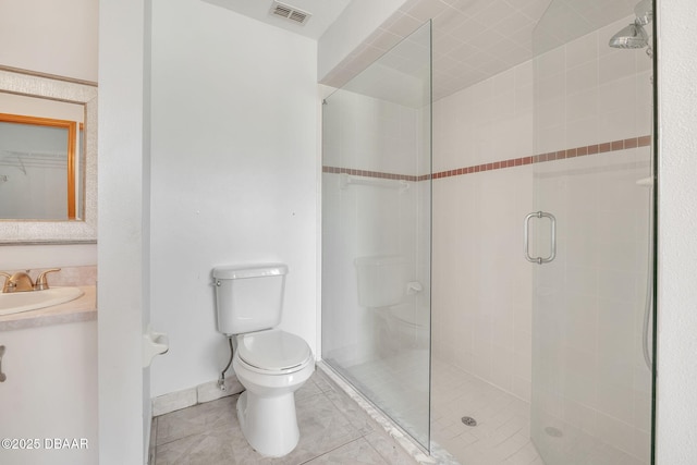 bathroom with tile patterned floors, vanity, toilet, and a shower with shower door