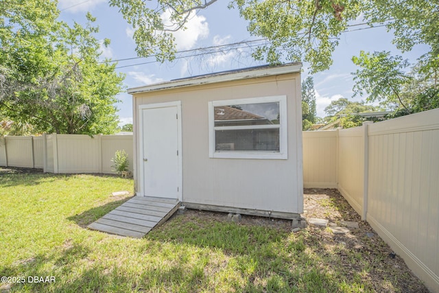 view of outbuilding with a lawn