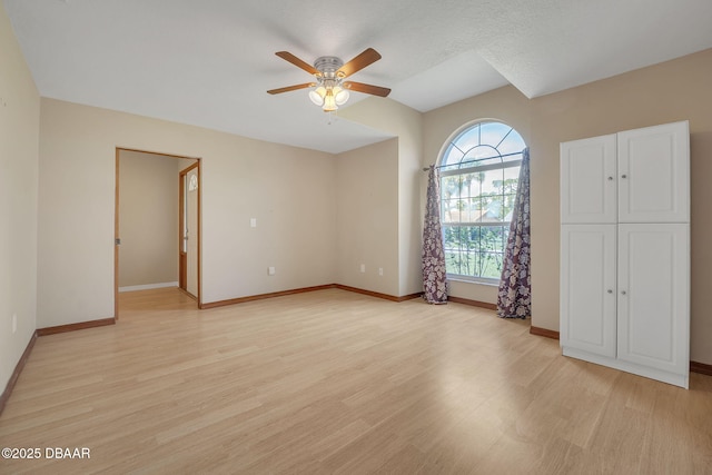 unfurnished bedroom with ceiling fan and light wood-type flooring