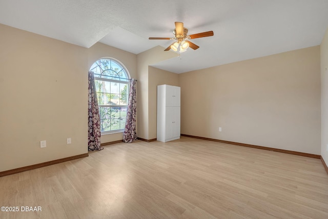 empty room featuring ceiling fan and light hardwood / wood-style flooring