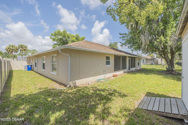 rear view of house featuring a lawn