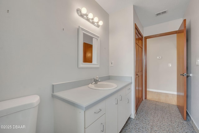 bathroom featuring vanity and toilet