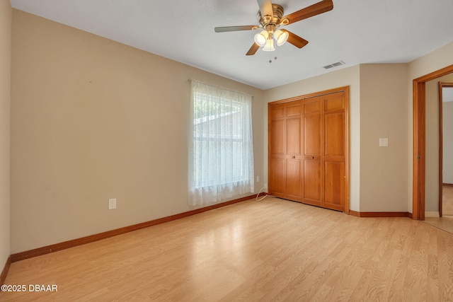 unfurnished bedroom featuring ceiling fan, a closet, and light hardwood / wood-style floors