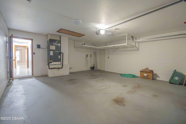 garage featuring a garage door opener and heating unit