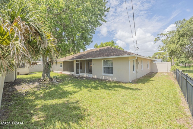 back of house featuring a yard