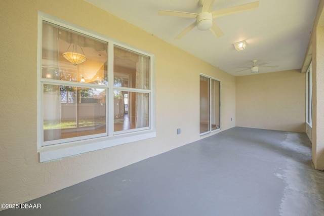 unfurnished sunroom with ceiling fan