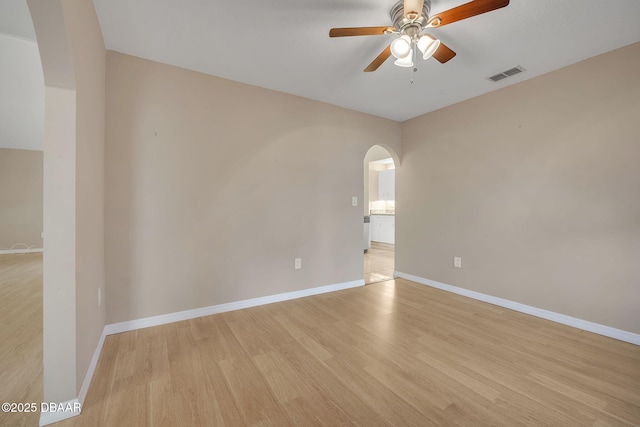 empty room featuring ceiling fan and light wood-type flooring