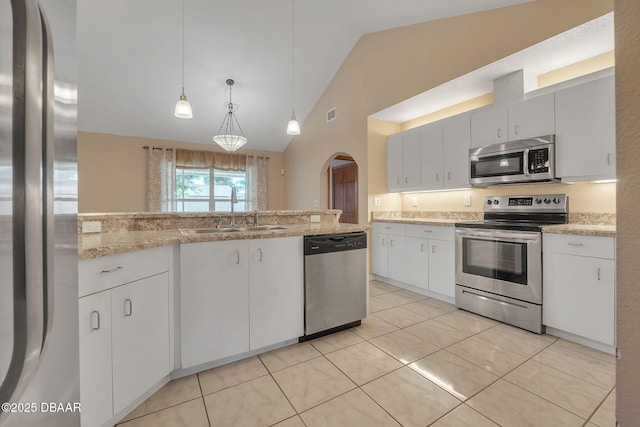 kitchen with appliances with stainless steel finishes, sink, light tile patterned floors, pendant lighting, and white cabinets