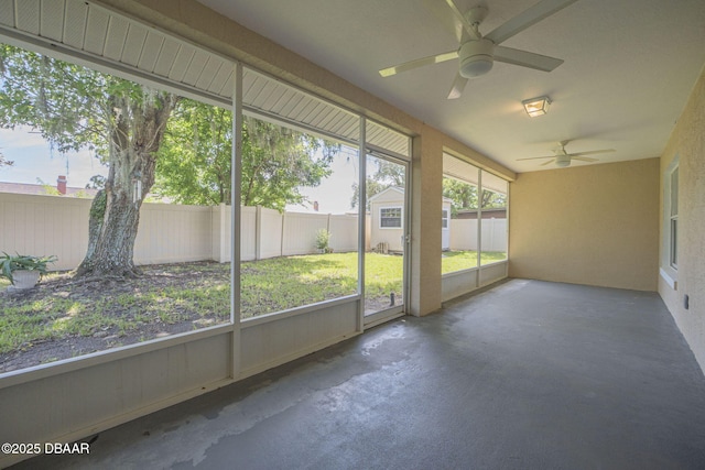 unfurnished sunroom featuring ceiling fan