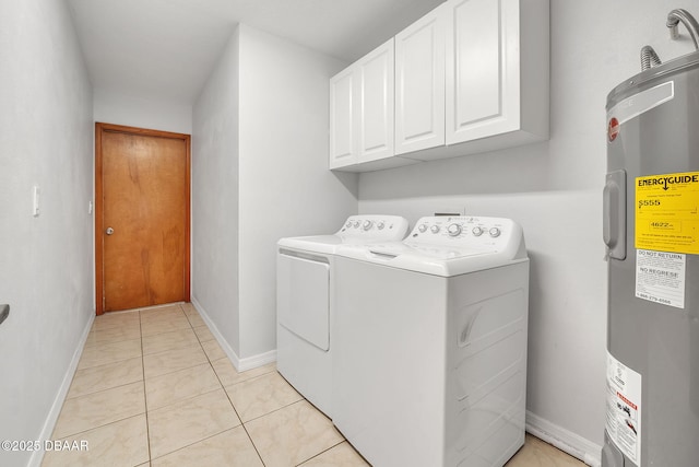 laundry area featuring washer and dryer, cabinets, light tile patterned floors, and water heater