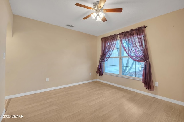 empty room featuring ceiling fan and light hardwood / wood-style floors