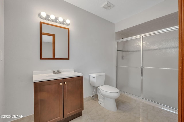 bathroom with a shower with door, vanity, and toilet