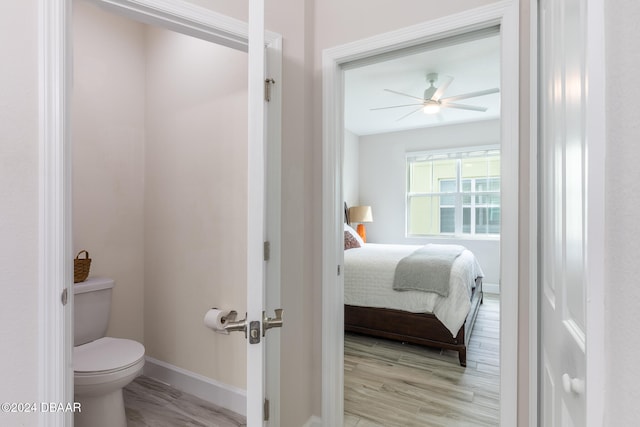 bathroom with toilet, wood-type flooring, and ceiling fan