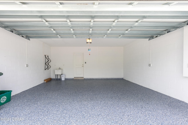 garage featuring sink and a garage door opener