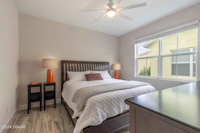 bedroom with ceiling fan and light wood-type flooring