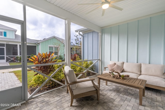 sunroom featuring ceiling fan and plenty of natural light