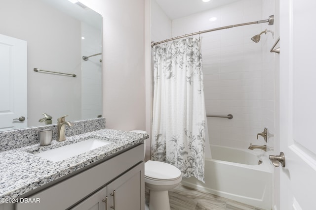 full bathroom with toilet, hardwood / wood-style floors, vanity, and shower / bath combination with curtain