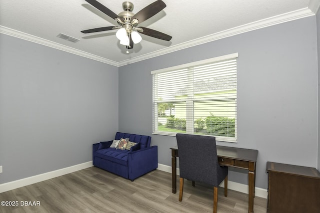 office area with ceiling fan, visible vents, crown molding, wood finished floors, and baseboards