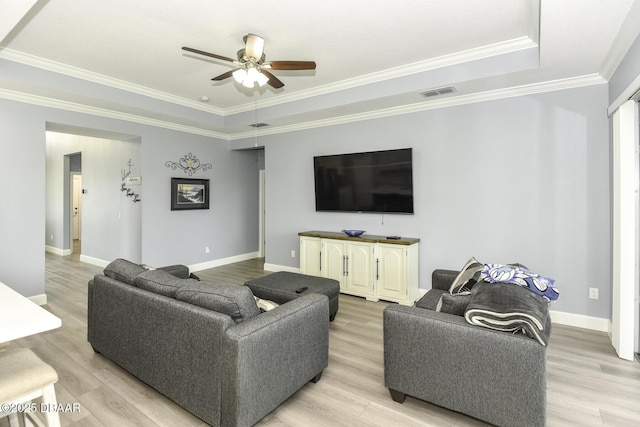 living area featuring crown molding, a ceiling fan, visible vents, and light wood-style flooring