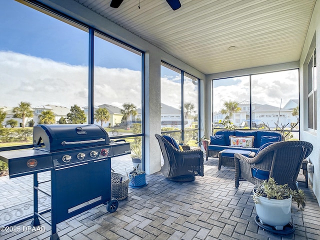 sunroom featuring ceiling fan and an outdoor hangout area