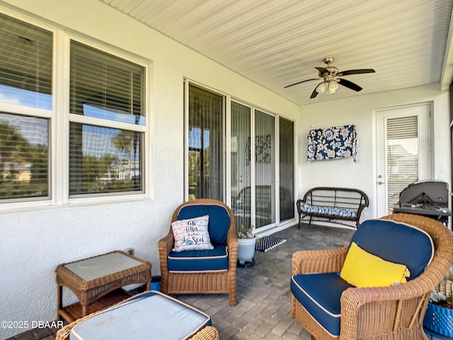 sunroom / solarium featuring ceiling fan