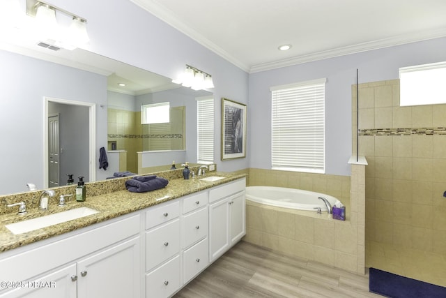 bathroom featuring wood finished floors, a sink, walk in shower, and a bath