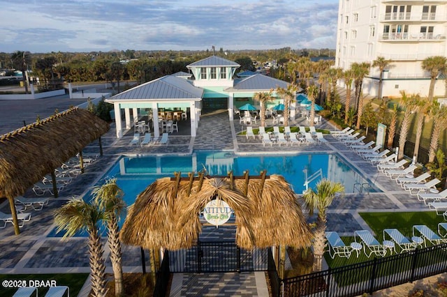 community pool with fence and a patio