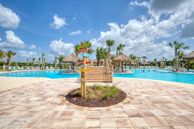 pool with a gazebo and a patio area