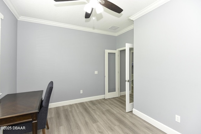 unfurnished office featuring ceiling fan, french doors, crown molding, wood finished floors, and baseboards