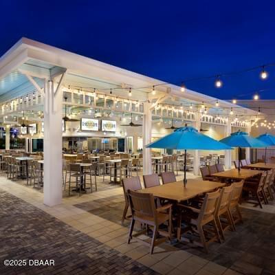 patio at twilight featuring a bar