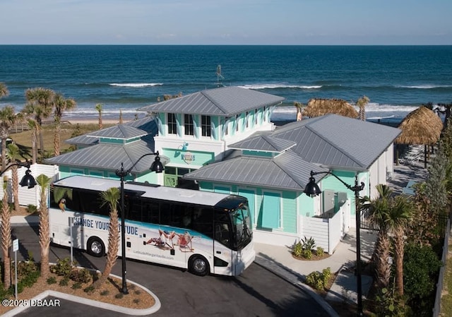 exterior space with a beach view and a water view